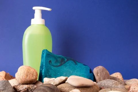 Piece of blue mint handmade soap lying on pebble Stock Photos