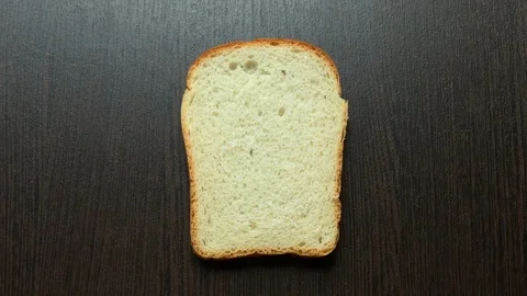 In a piece of bread carved heart on a dark background Stockbeeldmateriaal 103744314