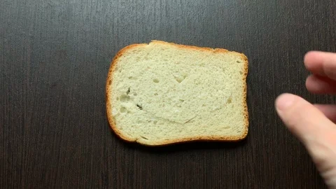 In a piece of bread carved heart on a dark background Stock Footage 103754864