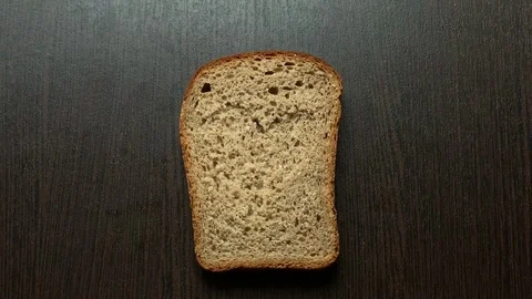 In a piece of bread carved heart on a dark background Stockbeeldmateriaal 103766871