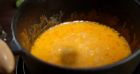 A piece of bread dipped in boiling cheese fondue. Stock Footage 129141835