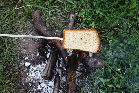 Piece of bread fried at the stake put on a skewer Stock Photos