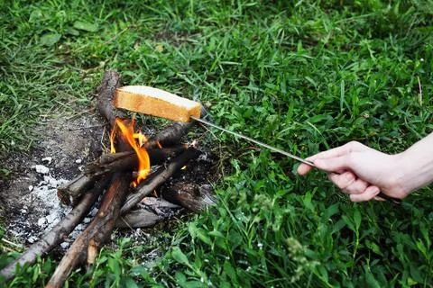 Piece of bread fried at the stake put on a skewer Stock Photos