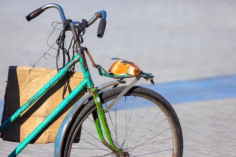 Piece of bread on the trunk of an old bicycle. food and transport. poverty an Stock Photos
