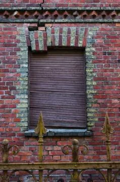 Piece of brickwork is breaking out of the window frame Stock Photos