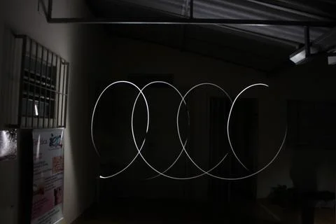 Piece of bright light with an abstract shape illustrated on a black backgroun Stock Photos