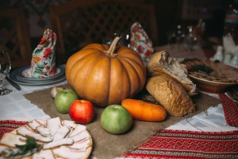 Piece of broken bread with pumpkin on the table. Food background Stock Photos