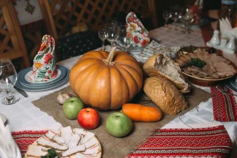 Piece of broken bread with pumpkin on the table Stock Photos