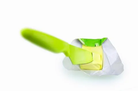 Piece of butter and a green knife Stock Photos