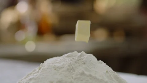 Piece of Butter is Dropping into The Dough Stock Footage 115863128