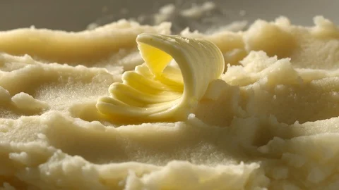 Piece of butter melting slowly on a mashed potato - Time-Lapse Stock Footage