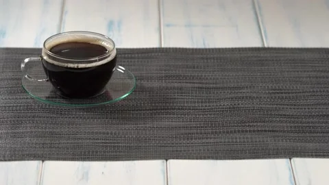 A piece of cake and a cup of coffee on the light wooden table. Stock Footage 157095421