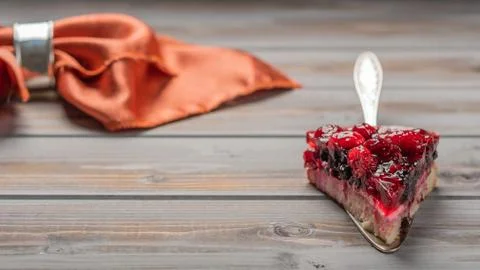 Piece of cake with berries: raspberry, currant, strawberry on a metal spatula on Stock Photos