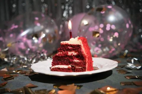A piece of cake with a candle 写真素材
