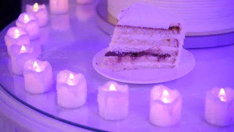A piece of cake in a circle of candles Stock Footage 163566598