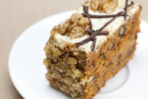 Piece of cake with nuts lying on the plate Stock Photos