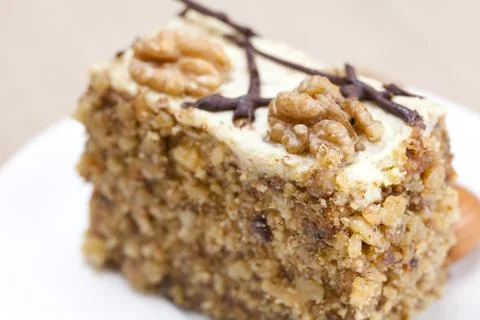 Piece of cake with nuts lying on the plate Stock Photos