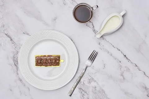 A piece of cake on a plate with a fork Stock Photos