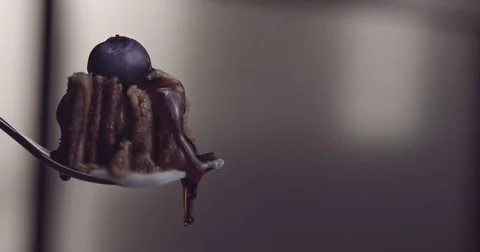 A piece of cake served in fork with mapple suryp moves to the right Stock Footage 76550466