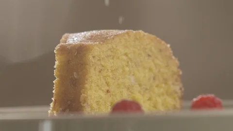 Piece of cake sprinkled with powdered sugar in slow motion Stock Footage 114879463