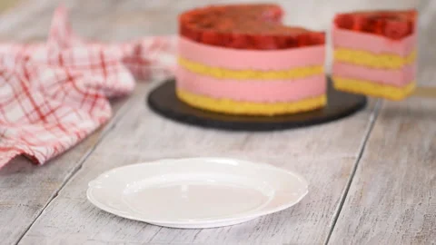 Piece of cake with a vanilla biscuit, raspberry mousse and jelly, sweet pastries Stock Footage 128418154