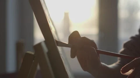 This piece captures the enchanting creative process in a sunlit setting, where Stock Footage 317021623