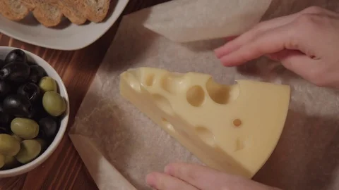 Piece of cheese, bread olive and greens Stock Footage 73919314