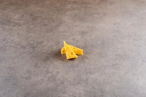 A piece cheese on a cement background. 写真素材