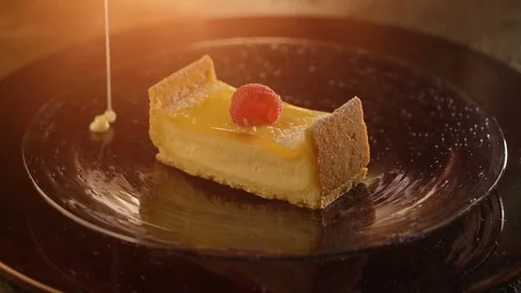 Piece of cheesecake pour a thin stream of sweet cream sauce Stock Footage 71553131
