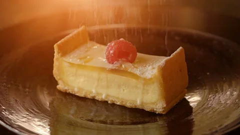 Piece of cheesecake. sprinkle with powdered sugar Stock Footage 71551968