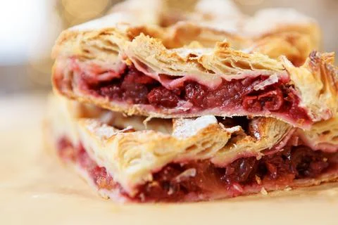 A piece of cherry pie on the dining table. The food is ready to eat. Puff pas Stock Photos
