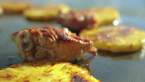 A piece of chicken fried with pineapples on a large grill Stock Footage 136329851