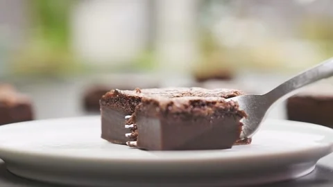 Piece of chocolate cake. Fork breaks off a piece of chocolate cake. Stock Footage 154937799
