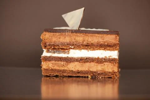 A piece of chocolate cake with mint on the table, close-up Stock Photos