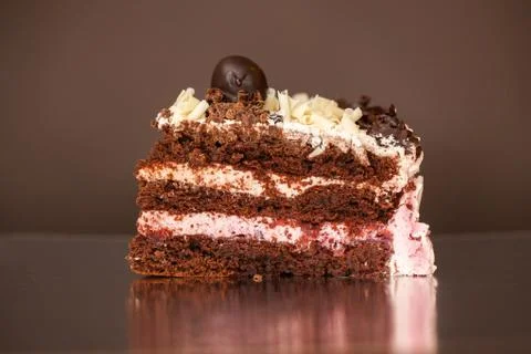 A piece of chocolate cake with mint on the table, close-up Stock Photos