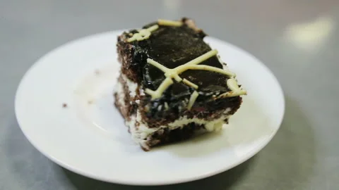 Piece of chocolate cake on a plate Stock Footage 87016262