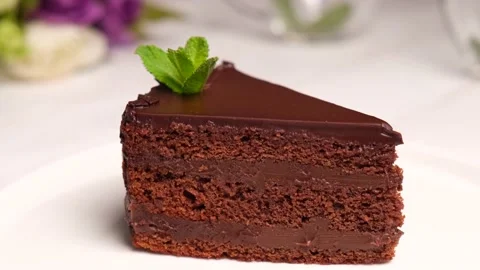 A piece of chocolate cake on a white plate Stock Footage 154631608