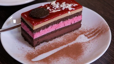 Piece of chocolate mousse cake on a white dish. Close up. Video stock 106816962