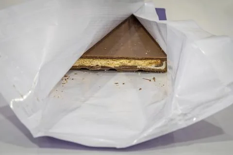 A piece of chocolate in a wrapper Stock-Fotos