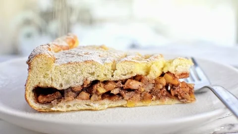 Piece of cinnamon apple pie sprinkle with powdered sugar in cafe. Fruit cake. Stock Footage 236476722