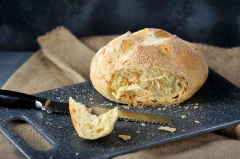 Piece of corn white bread cut from a loaf Stock Photos