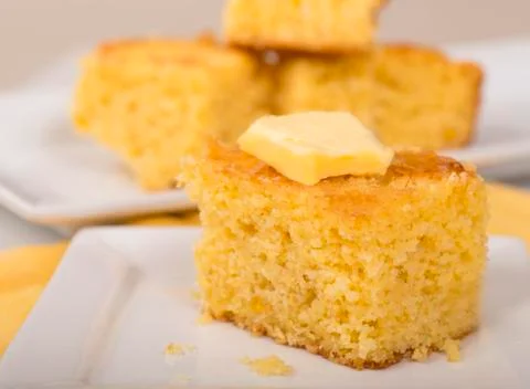Piece of cornbread with butter Stock Photos