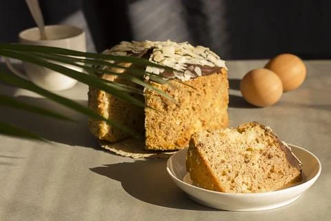 A piece of delicate Easter cake with dark chocolate and almonds with an exqui Stock Photos