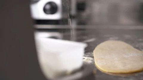 A piece of dough is on the table and hands take more flour from the box, Stock Footage 102164310