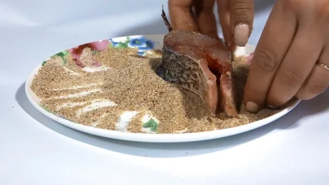 A piece of fish showered breadcrumbs for baking Video stock 105650393