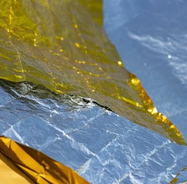 A piece of foil is folded into a triangle Stock Photos