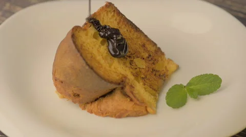 A piece of fresh delicious cake with chocolate sauce Stock Footage 59163413