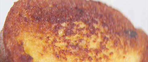 Piece of fried bread close-up 4K anamorphic video Stock Footage 320520536