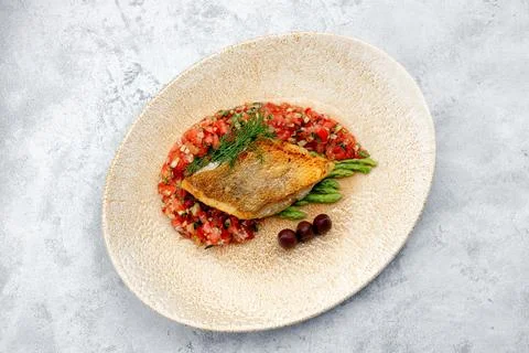 A piece of fried fish pike perch with vegetables Stock Photos