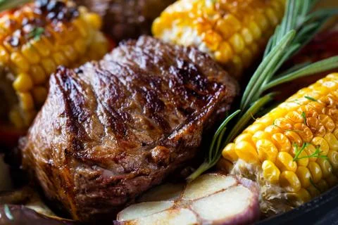 Piece of fried meat surrounded by corn Stock Photos